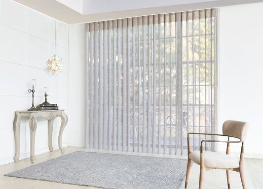 Luxx Shades Leaf vanes on a wide window in a bright living room