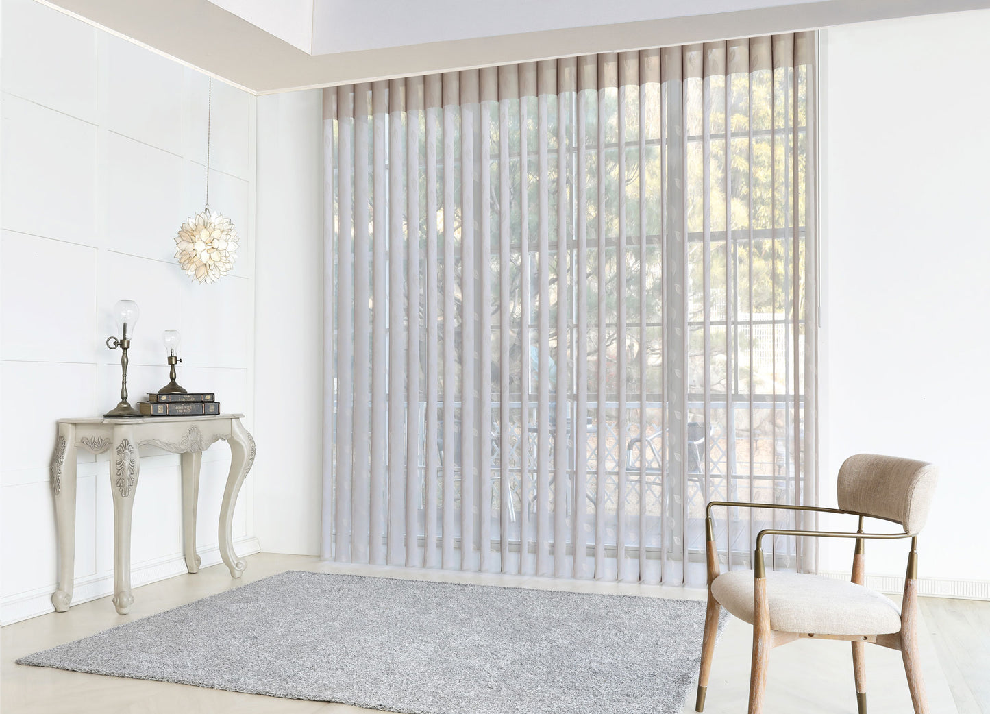 Luxx Shades Leaf vanes on a wide window in a bright living room