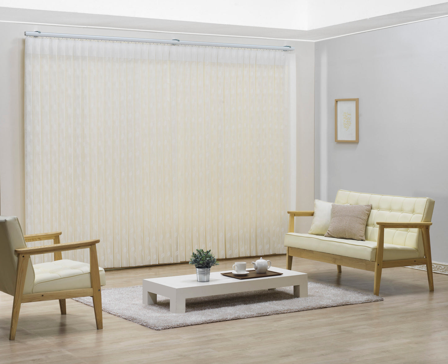 Luxx Shades Leaf in Ivory on a living room window with timber armchairs